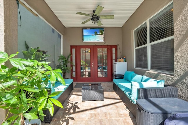 entrance to property with an outdoor living space, a patio, ceiling fan, and french doors