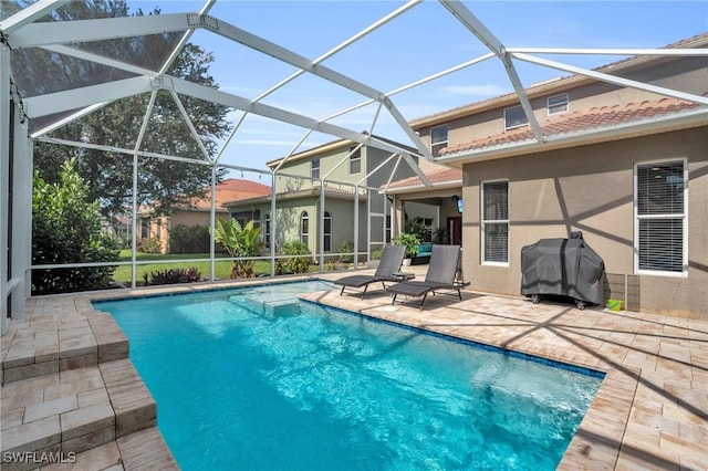 view of pool with area for grilling, a patio, and glass enclosure