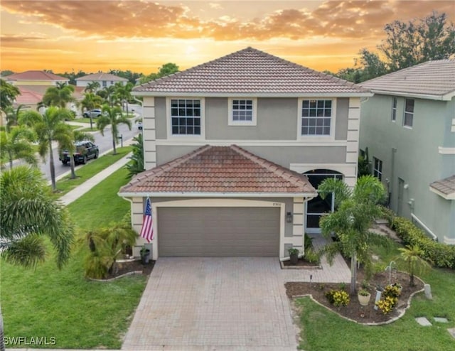 8900 Spring Mountain Way, Fort Myers, FL 33908 - view of front facade featuring a tile roof, stucco siding, decorative driveway, and a front yard