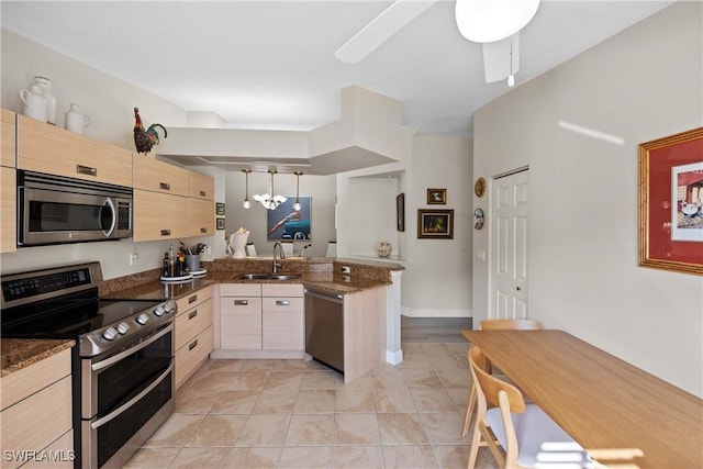 kitchen with kitchen peninsula, light brown cabinets, sink, and stainless steel appliances