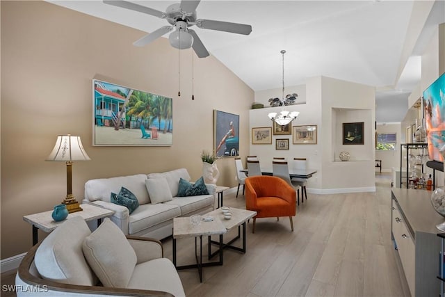 living room with ceiling fan with notable chandelier, vaulted ceiling, and light wood-type flooring