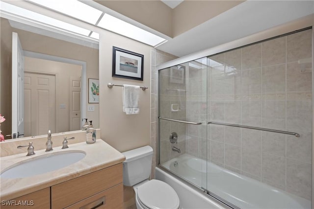 full bathroom featuring toilet, enclosed tub / shower combo, and vanity