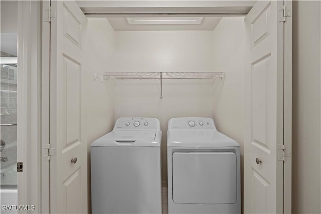 laundry area with washing machine and clothes dryer