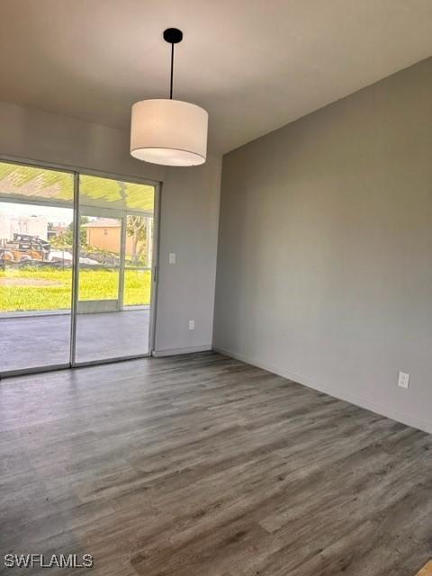 empty room with dark hardwood / wood-style flooring