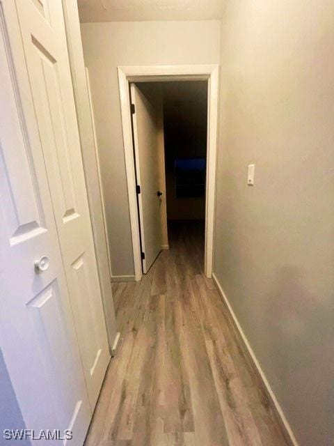 hallway with light wood-type flooring