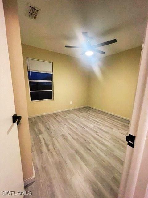 empty room with light hardwood / wood-style floors and ceiling fan