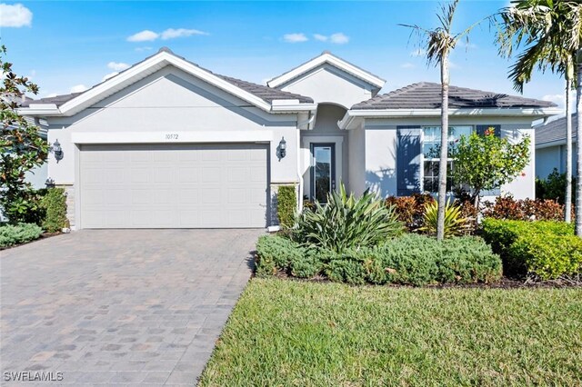 single story home with a front yard and a garage