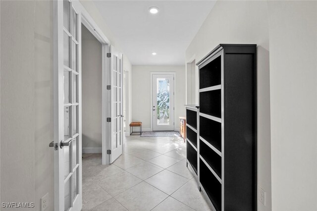 hallway with light tile patterned floors and french doors