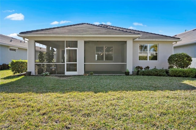 back of house featuring a sunroom and a yard