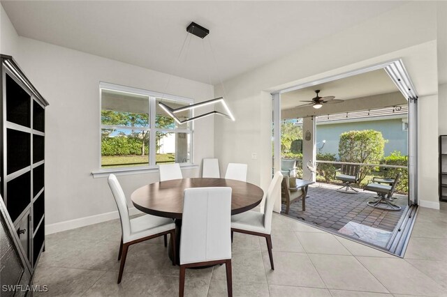 dining room with ceiling fan and light tile patterned flooring