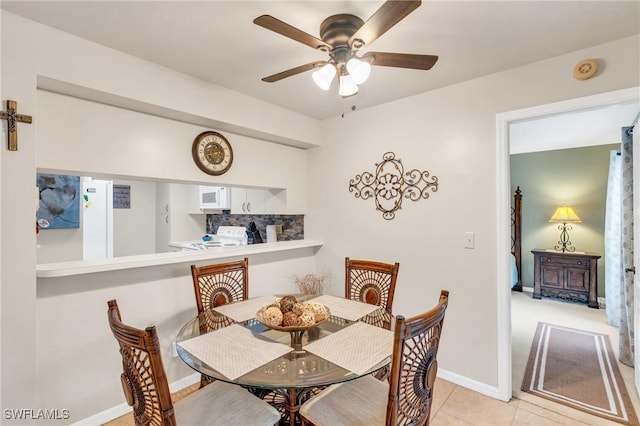 tiled dining room featuring ceiling fan