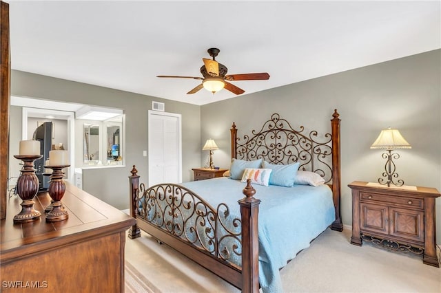 bedroom featuring light carpet, a closet, and ceiling fan