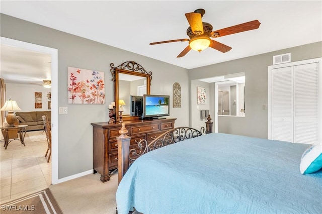 bedroom featuring ceiling fan, light tile patterned floors, and a closet