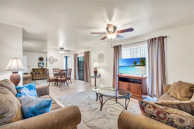 tiled living room featuring ceiling fan