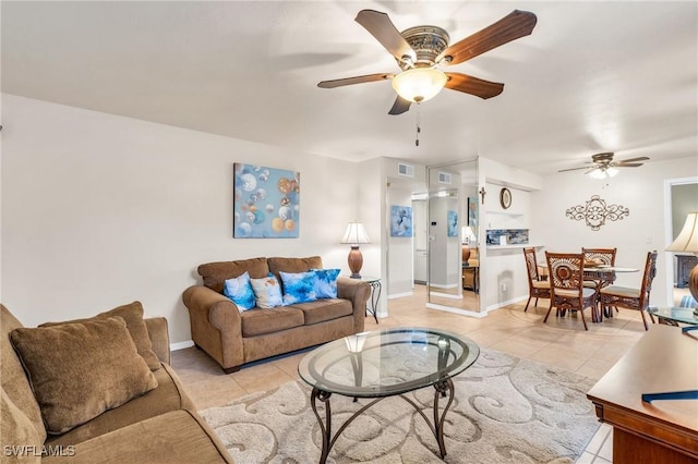 tiled living room with ceiling fan