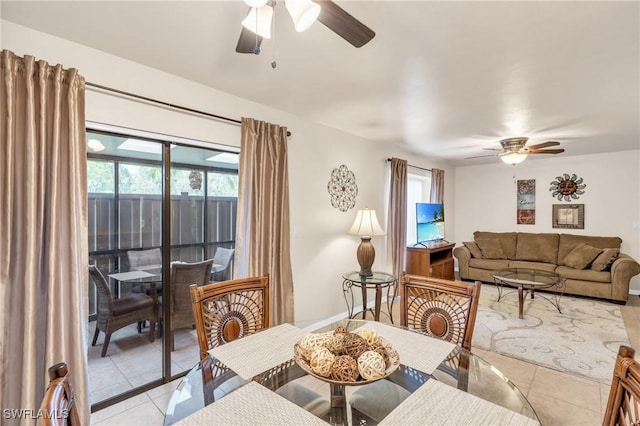 tiled dining space with ceiling fan