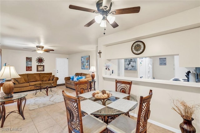 tiled dining room with ceiling fan