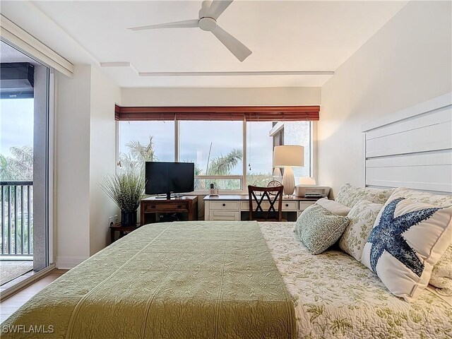 bedroom with hardwood / wood-style flooring, access to exterior, and ceiling fan