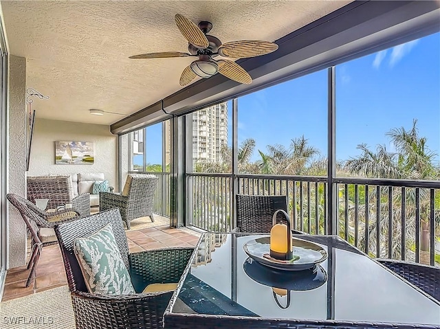 sunroom featuring ceiling fan