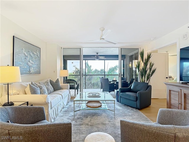 living room featuring light hardwood / wood-style floors, floor to ceiling windows, and ceiling fan