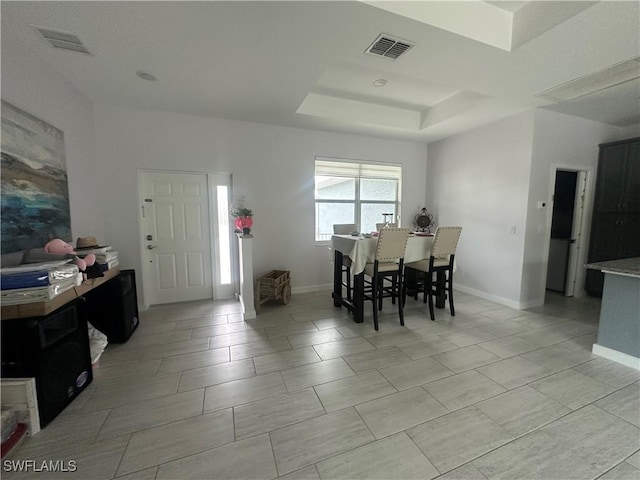 dining room with a raised ceiling