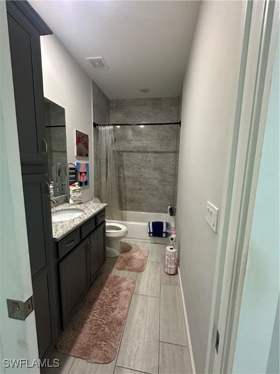 full bathroom featuring toilet, vanity, and shower / bath combination with curtain