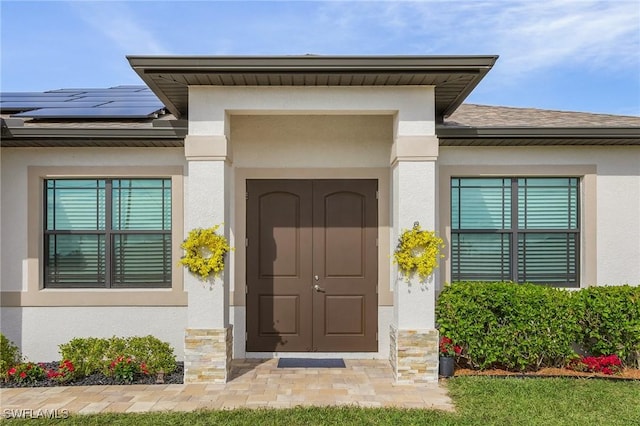 doorway to property featuring solar panels