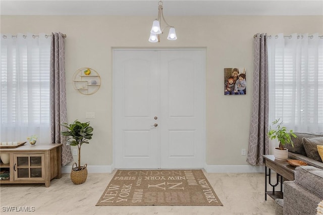 entryway with a chandelier