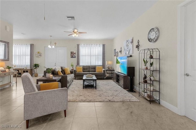 tiled living room with ceiling fan