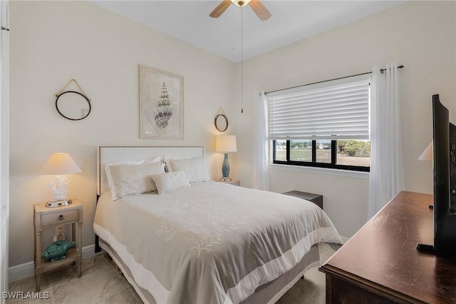 bedroom with ceiling fan and tile patterned flooring