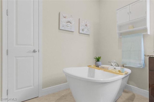 bathroom with a washtub and vanity