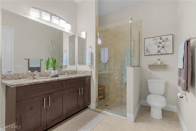 bathroom featuring toilet, tile patterned floors, a shower with shower door, and vanity