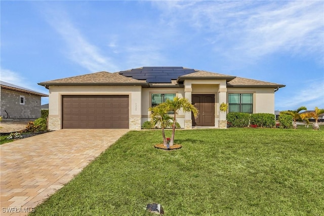 prairie-style home with a front lawn, a garage, and solar panels