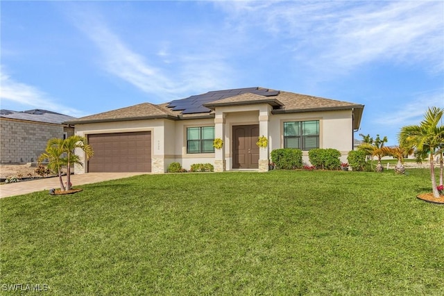 prairie-style home with a front yard, a garage, and solar panels