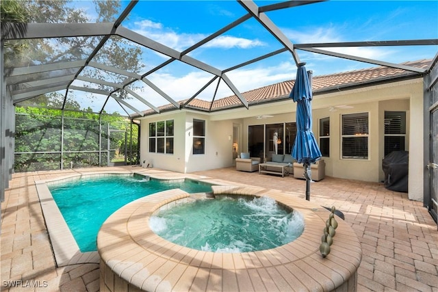 back of house featuring ceiling fan, a pool with hot tub, outdoor lounge area, glass enclosure, and a patio