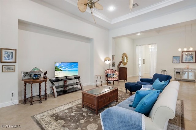 tiled living room featuring ceiling fan, a tray ceiling, and ornamental molding