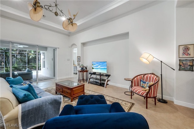 living room with ceiling fan, a towering ceiling, light tile patterned flooring, and crown molding