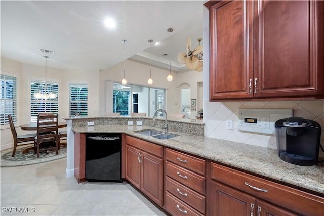 kitchen featuring decorative light fixtures, sink, light stone counters, and black dishwasher