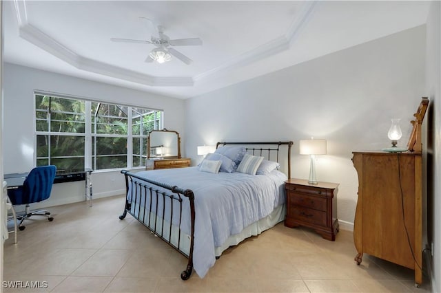 tiled bedroom featuring ceiling fan and a tray ceiling