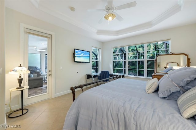 bedroom featuring ceiling fan, light tile patterned floors, and a raised ceiling