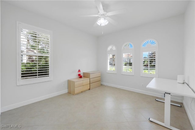 unfurnished office featuring ceiling fan