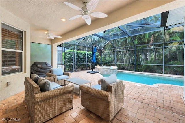 view of swimming pool featuring ceiling fan, glass enclosure, an in ground hot tub, and a patio