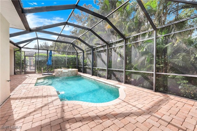 view of swimming pool with a lanai, a patio area, and an in ground hot tub