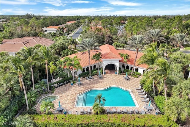 view of swimming pool featuring a patio area and an in ground hot tub