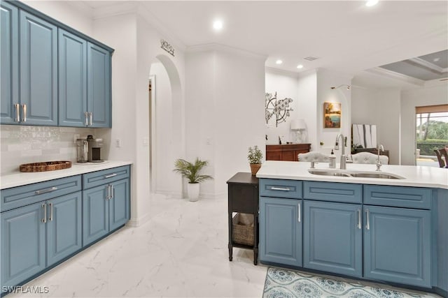 kitchen featuring tasteful backsplash, blue cabinets, sink, and crown molding