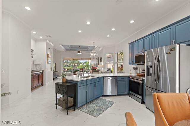 kitchen with ceiling fan, appliances with stainless steel finishes, ornamental molding, and blue cabinetry