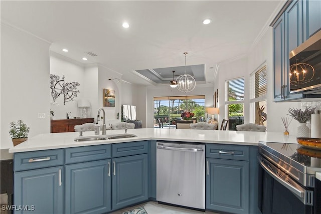 kitchen featuring a notable chandelier, kitchen peninsula, sink, appliances with stainless steel finishes, and blue cabinetry