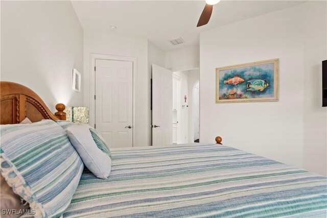 bedroom with ceiling fan and a closet