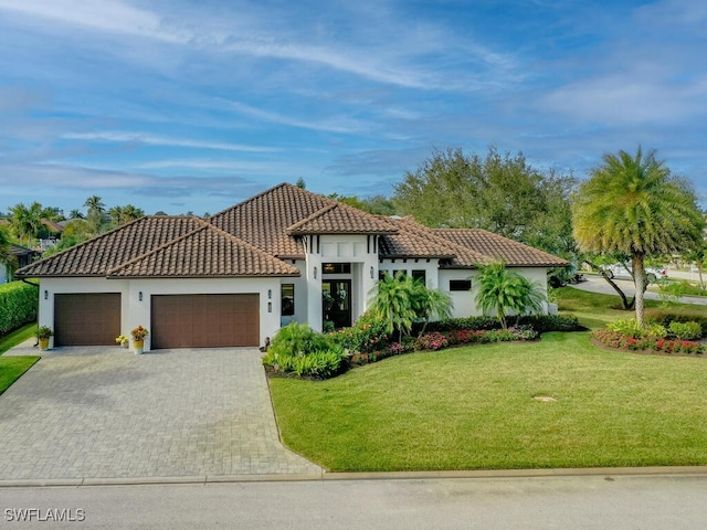 mediterranean / spanish-style home with a garage and a front yard