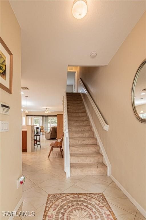 stairway featuring tile patterned flooring